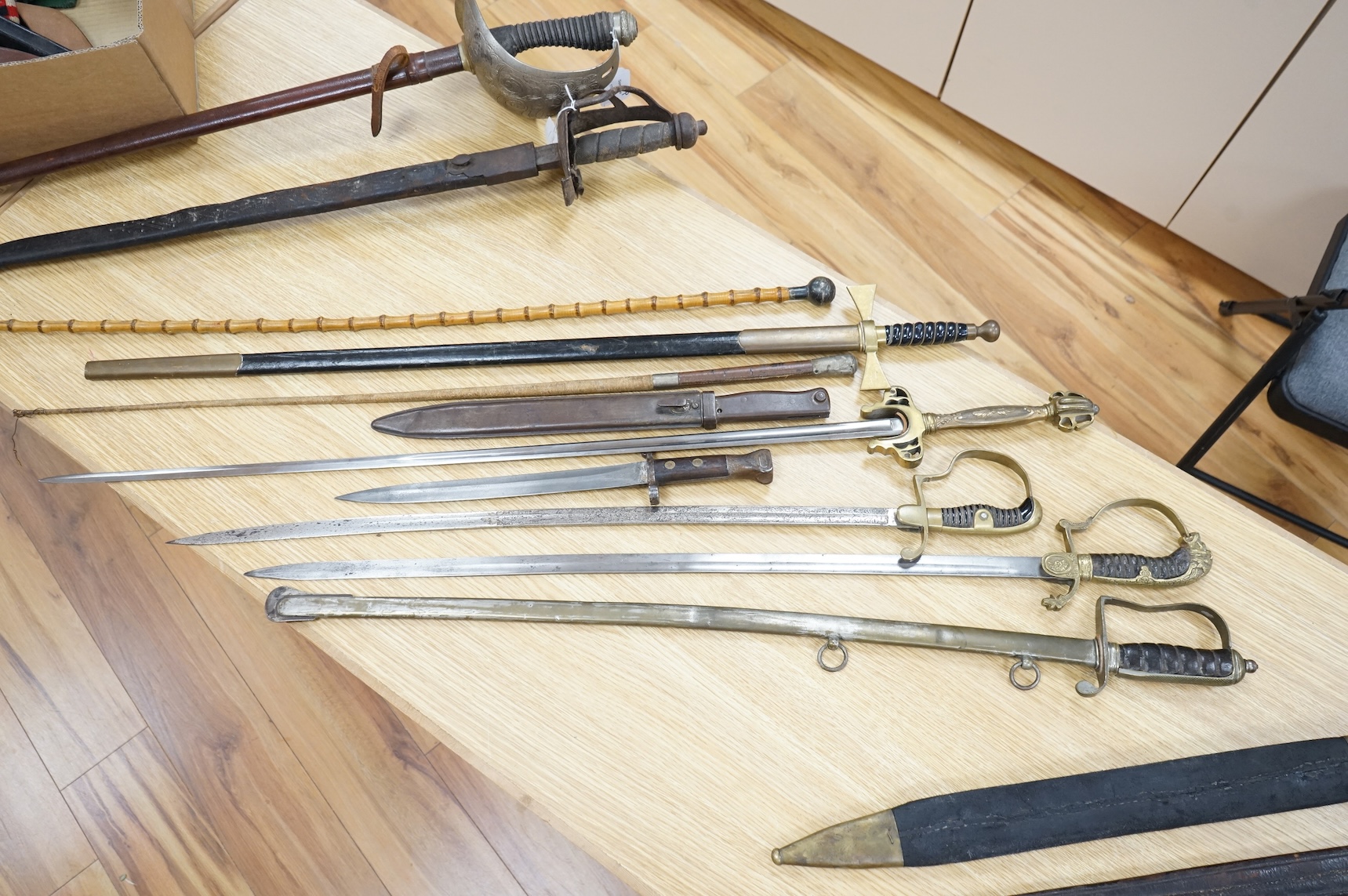An Imperial German presentation infantry officer’s sword dated 1919/20, another similar with plain blade and brass stirrup hilt, another similar, plain in steel scabbard, a Wilkinson masonic sword probably circa 1950, a